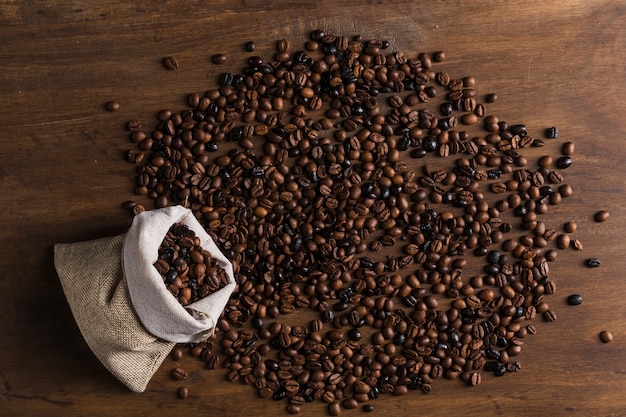 Free photo sack with scattered coffee beans