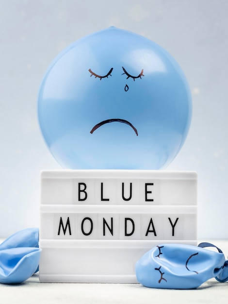 Free photo sad balloon with light box for blue monday