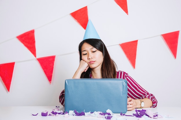 Sad birthday girl with gift box