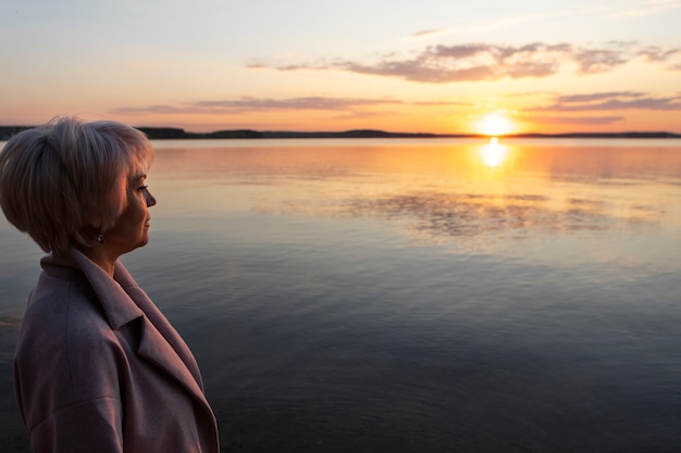 Free photo sad and contemplative person near lake