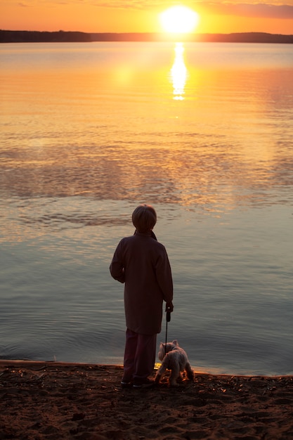 Free photo sad and contemplative person near lake