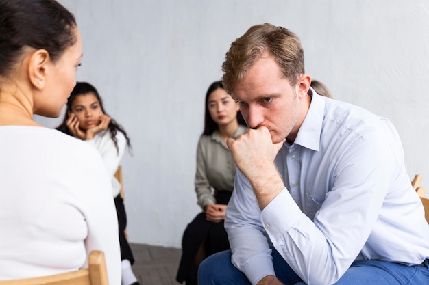 Sad man at a group therapy session