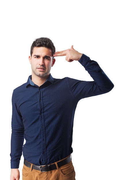 Sad man showing gun gesture with his hand