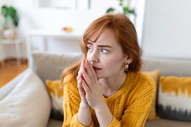 Sad woman feels miserable desperate sit on sofa look out the window thinking about personal troubles does not see way out of difficult life situation Break up heartbreak cheated girl concept