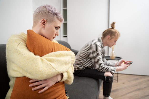 Free photo sad woman hugging pillow medium shot