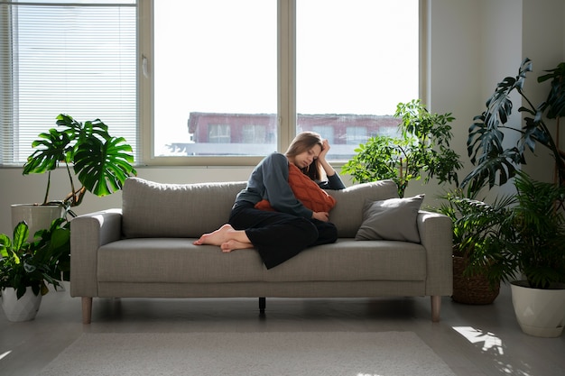 Free photo sad young woman at home