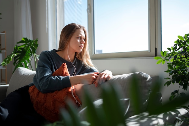 Free photo sad young woman at home