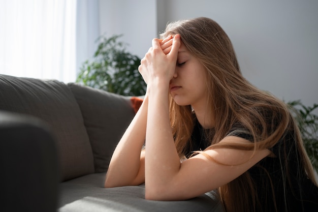 Sad young woman at home