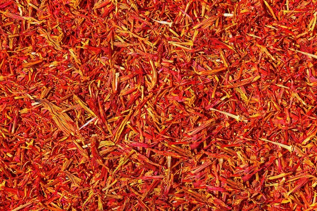 Saffron threads on dark background Crocus sativus or commonly known as the quotsaffron crocusquot Flat lay aromatic spices and seasonings