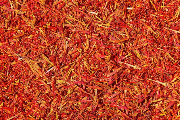 Saffron threads on dark background Crocus sativus or commonly known as the quotsaffron crocusquot Flat lay aromatic spices and seasonings