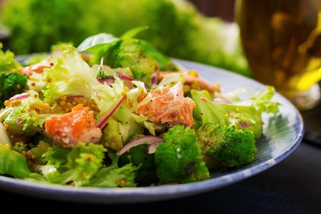 Salad of stewed fish salmon, broccoli, lettuce and dressing. Fish menu. Dietary menu. Seafood - salmon.