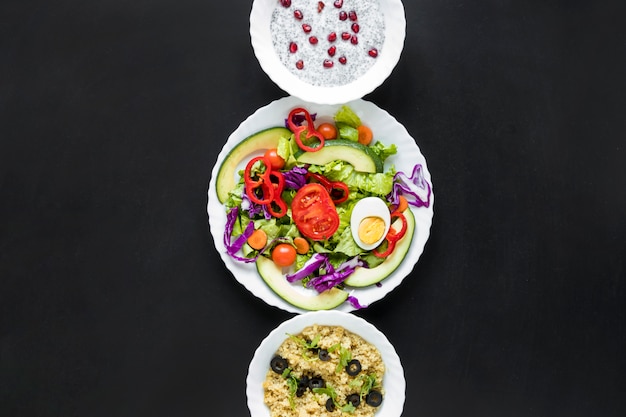 Free photo salad with chia seed pudding and healthy oats arranged in a row