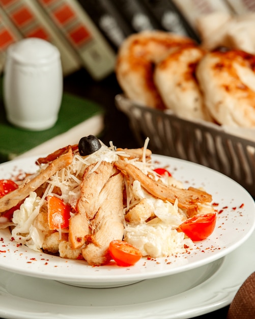 salad with chicken crackers and parmesan top view