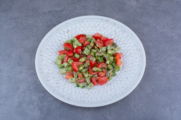 Salad with chopped tomatoes, green beans and herbs