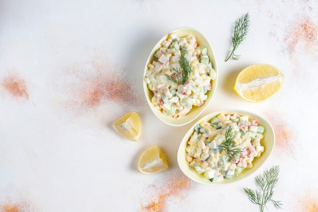 Salad with crab sticks, eggs, corn and cucumber.