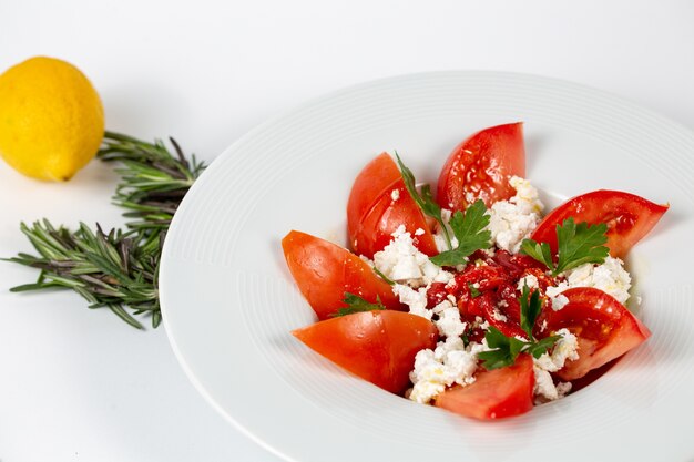 Salad with fresh tomatoes greens and white cheese