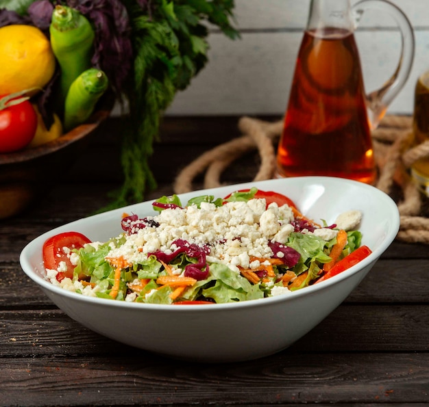 Salad with vegetables and cottage cheese on the table