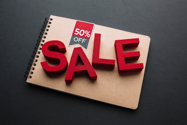 Sale concept on notebook on black background