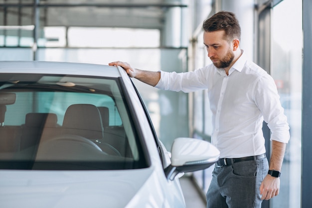 Salesman at a car showroom