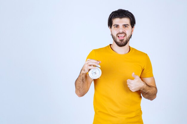 A salesman holding and promoting the alarm clock.