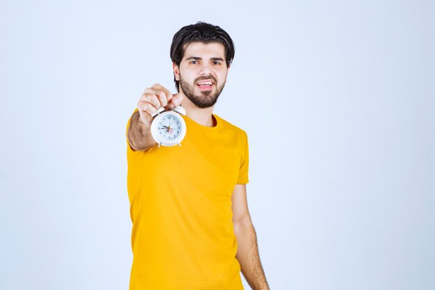 A salesman holding and promoting the alarm clock.