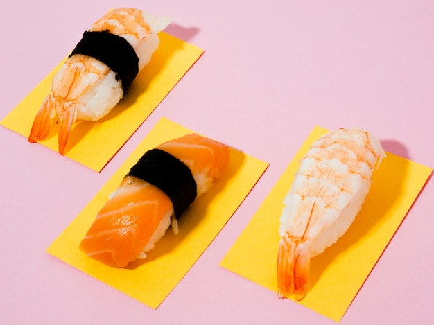 Free Photo salmon and shrimp sushi on rose background