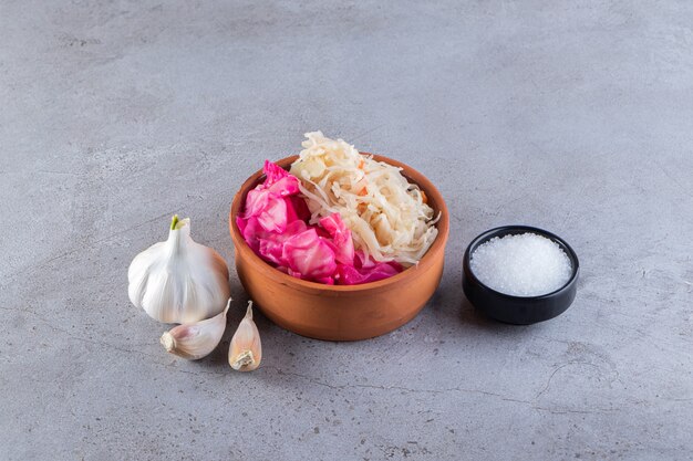 Salty cabbage placed on stone table.