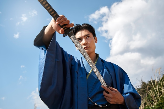 Free photo samurai with sword outdoors