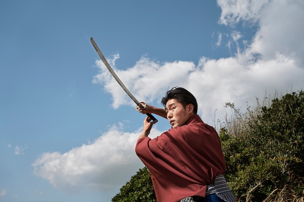 Free photo samurai with sword outdoors