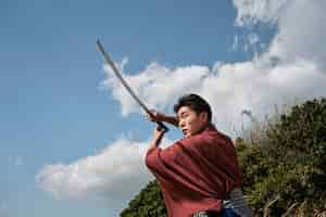 Free photo samurai with sword outdoors