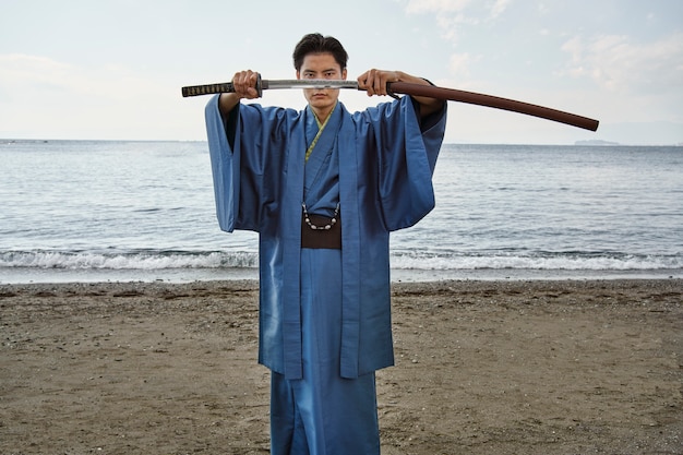 Free photo samurai with sword outdoors