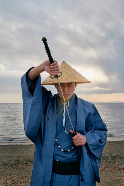 Free photo samurai with sword outdoors