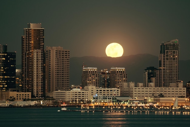 Free photo san diego downtown skyline and full moon over water at night