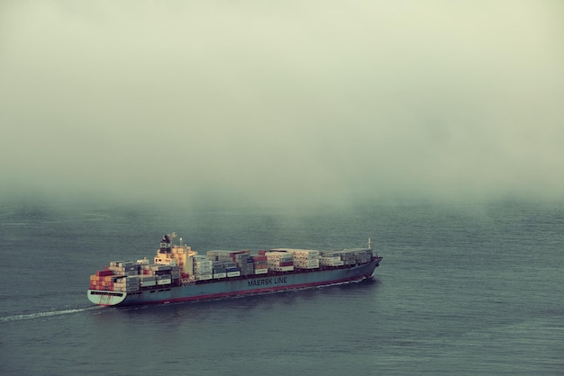 Free Photo san francisco, ca - may 11: cargo ship pass by san francisco bay in fog on may 11, 2014 in san francisco. sf is the most densely settled large city in california and the second-most in us.