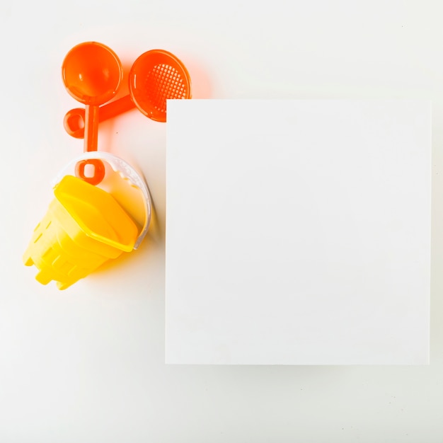 Free photo sand play set near paper sheet