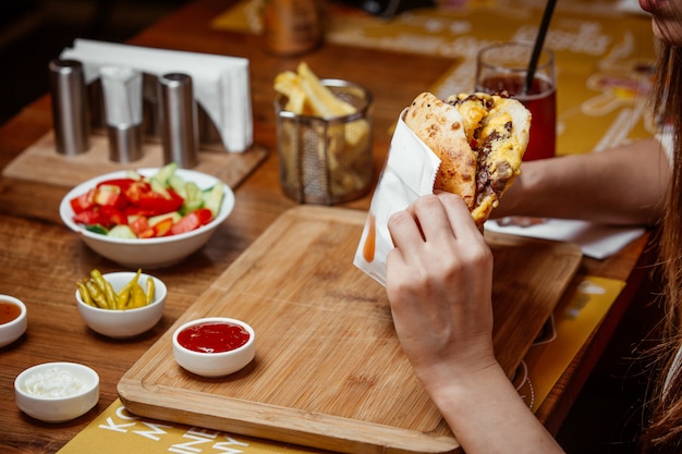 Sandwich in pita bread on wooden board