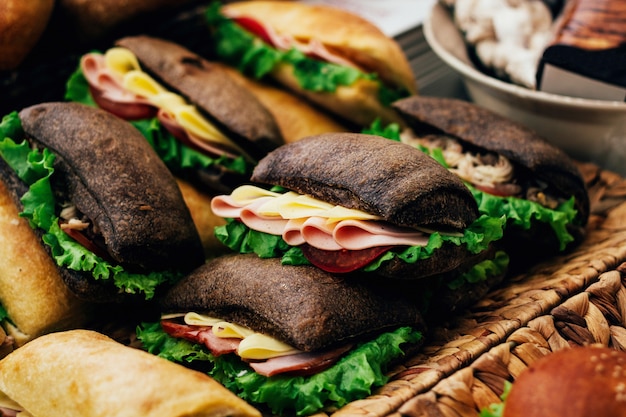 Sandwiches with ham and cheese in black and white bread