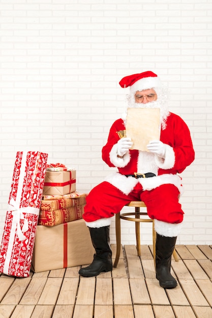 Santa Claus concentrated on reading Christmas letter