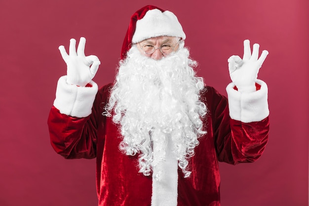 Free Photo santa claus in glasses showing okay gestures 