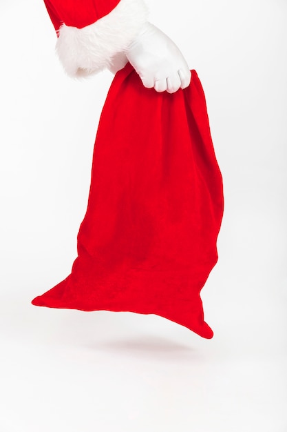 Santa Claus hands holding red sack of gifts