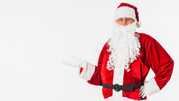 Free Photo santa claus in hat showing something with hand