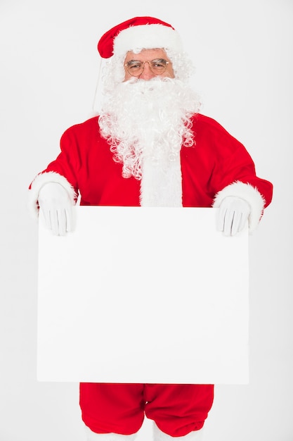 Free Photo santa claus holding big empty paper