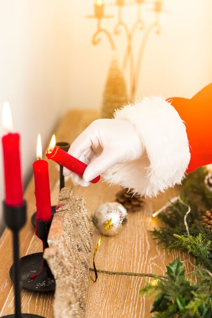 Santa Claus lighting up Christmas candles