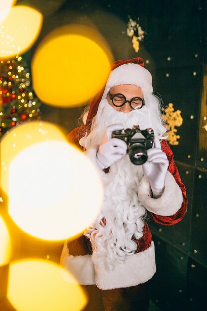 Santa claus making photos on camera