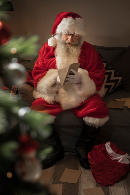 Free Photo santa claus opening a letter from a kid