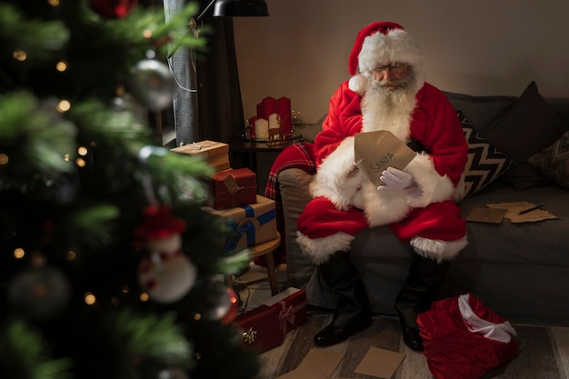 Free photo santa claus opening a letter from a kid