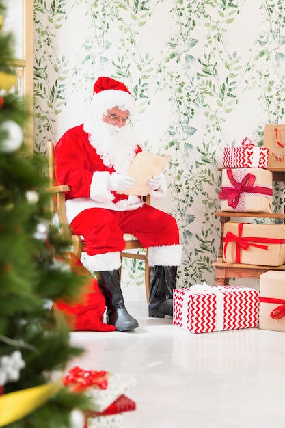 Free photo santa claus reading wish list