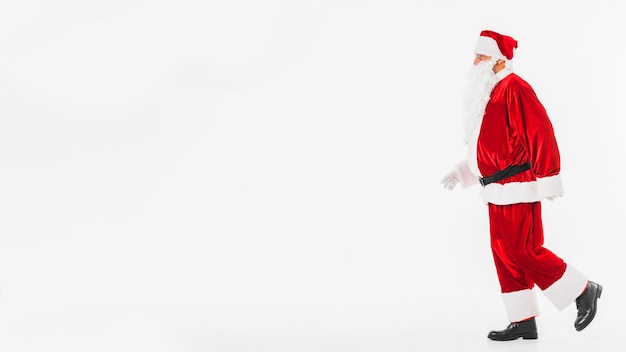 Free photo santa claus in red walking somewhere