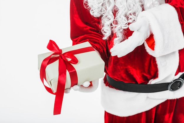 Free photo santa claus showing gift box in hand