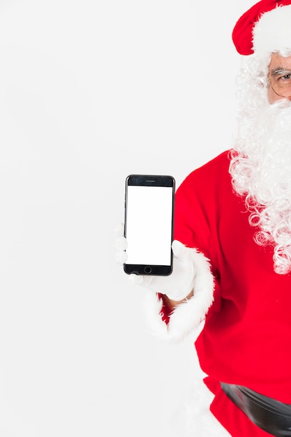 Free photo santa claus showing smartphone screen